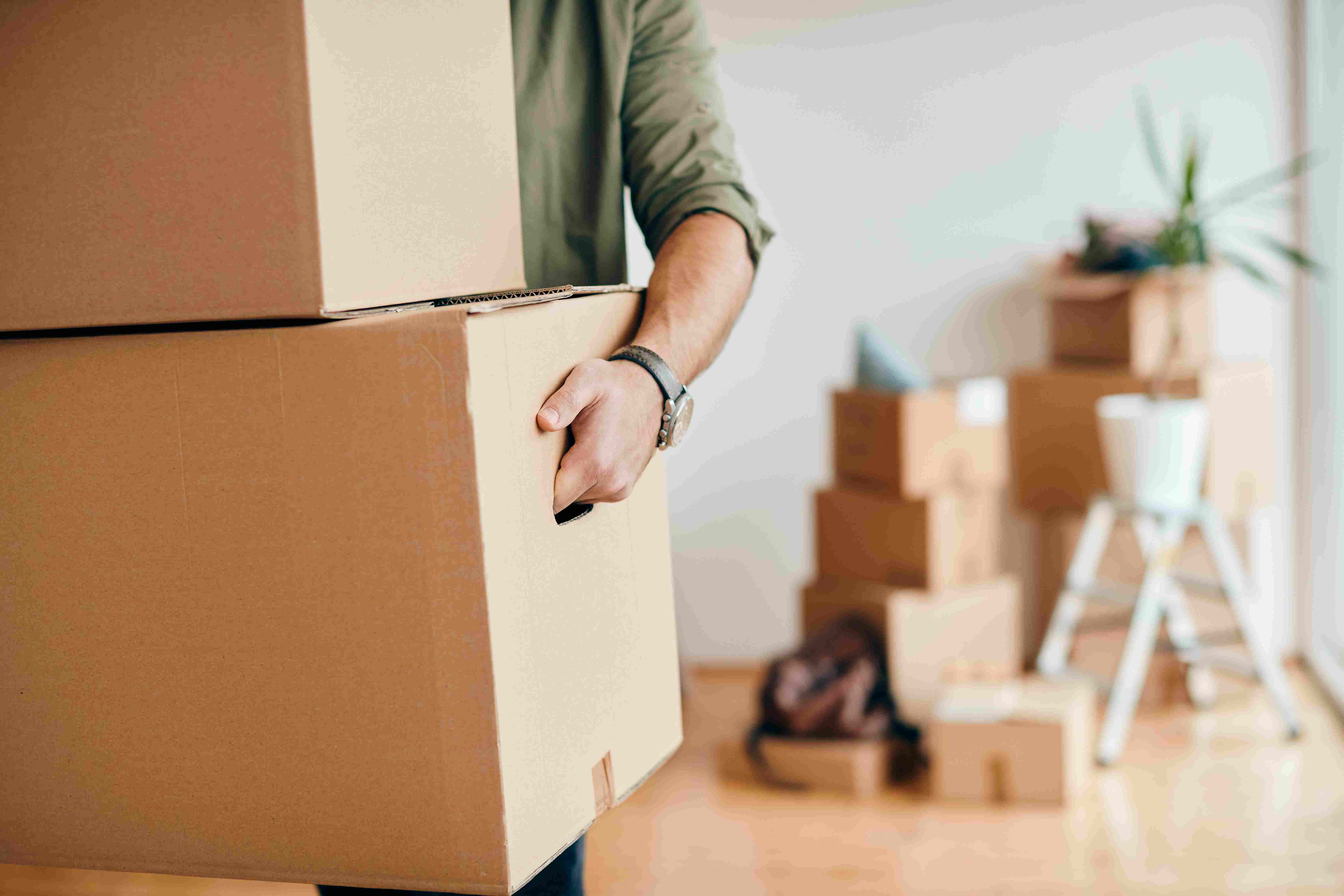 Moving team preparing boxes in a bright apartment